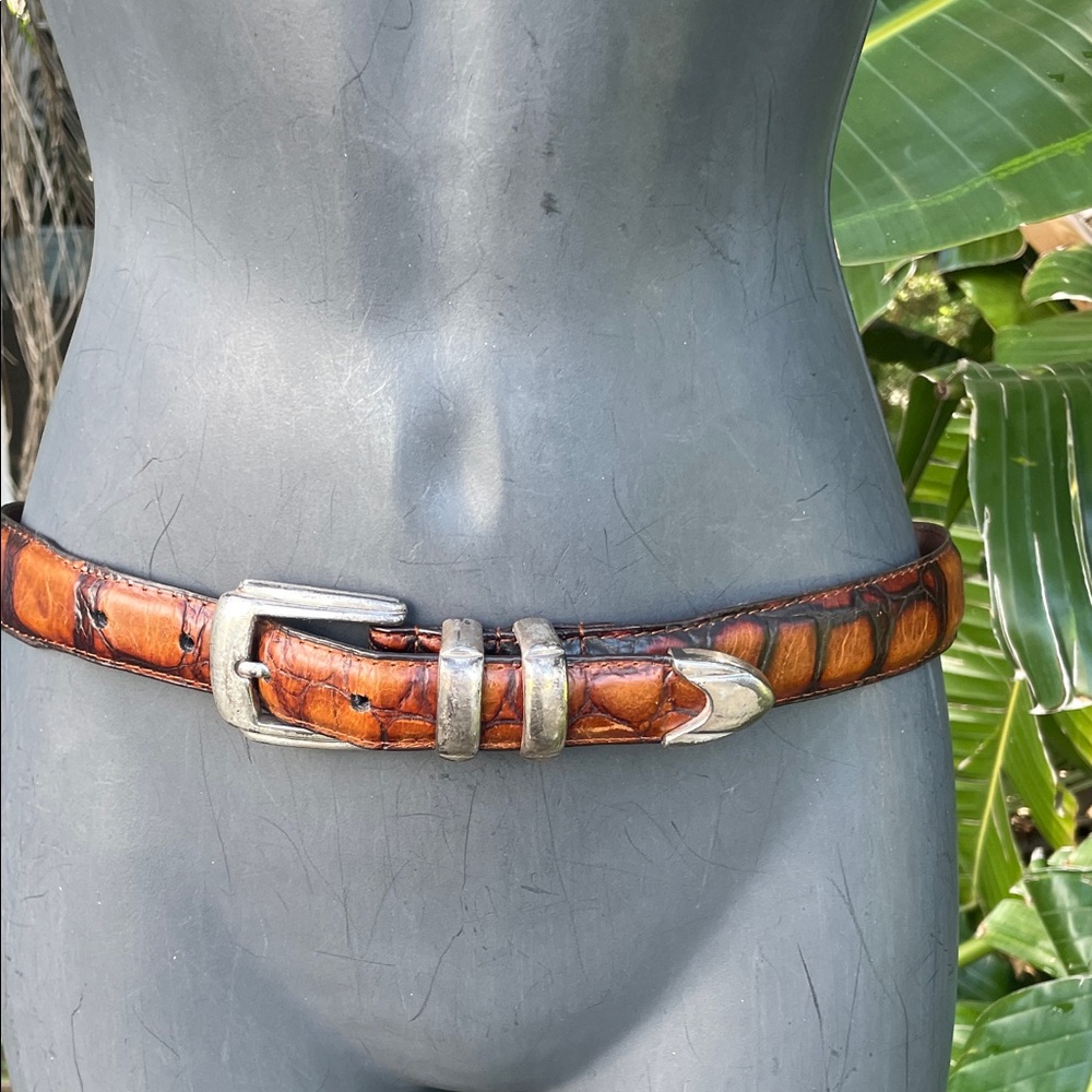 alligator leather belt with silver western style buckle and closings.